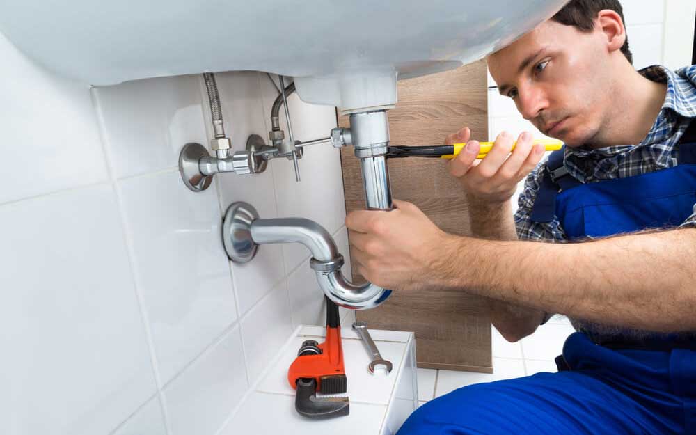 plumber tightening up a drain